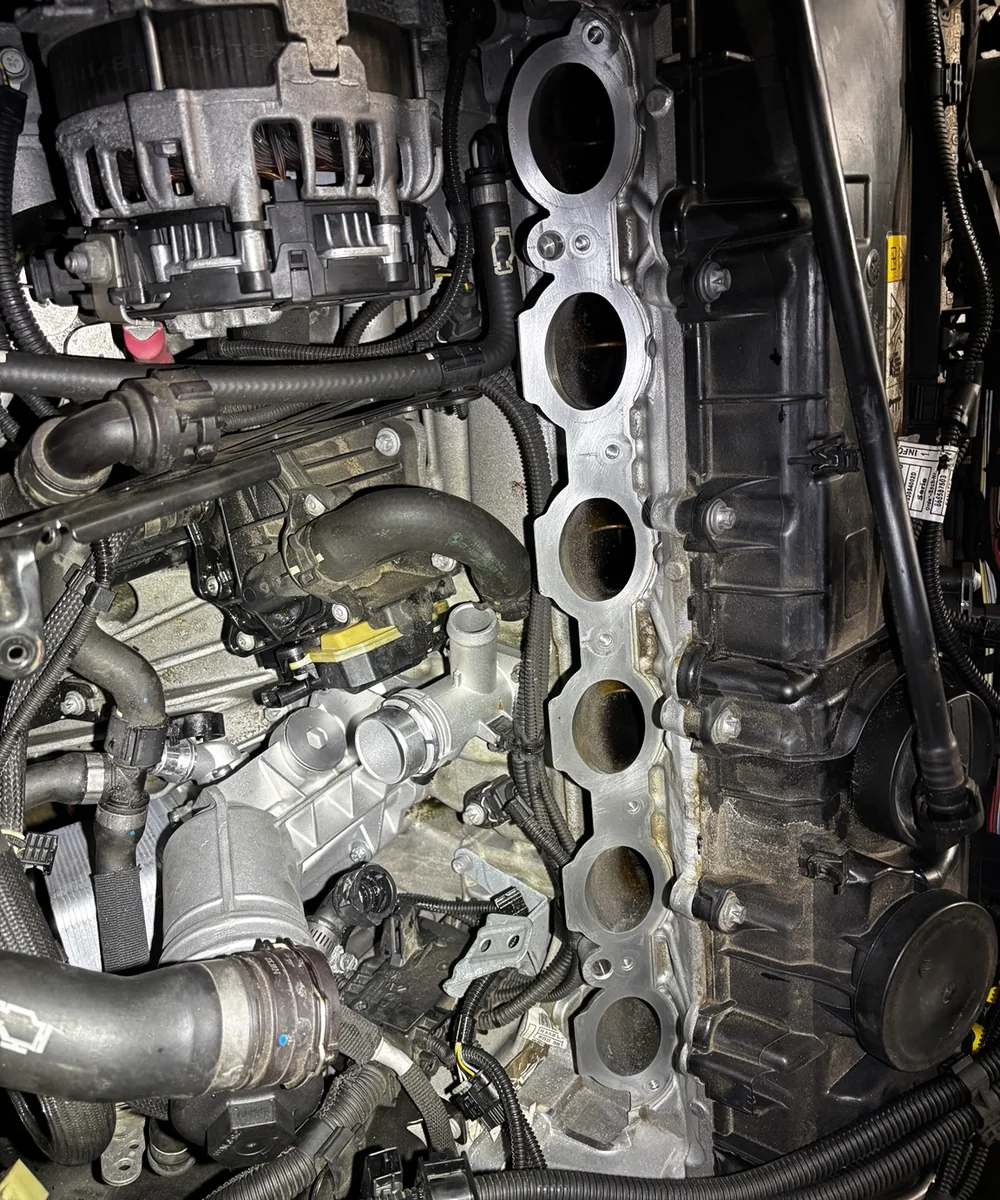 Close-up of an engine with intake components removed for service